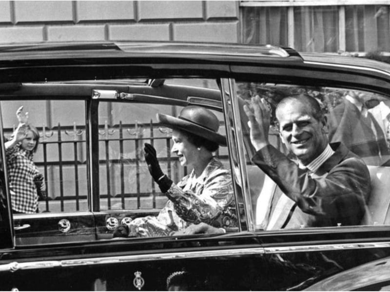 Greeting the crowds and waving outside the Mansion House.