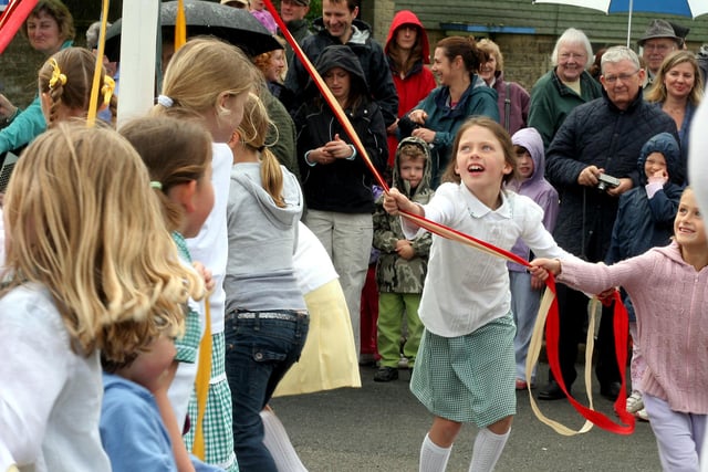Ashover Brownies entertain the crowd with their maypole dancing at the May Day gala in 2010.