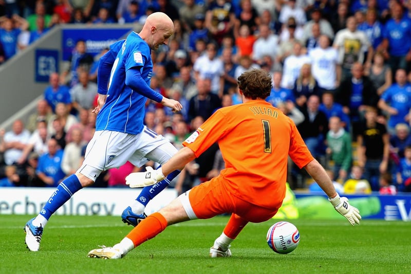 Danny Whitaker rounds Alan Julian of Gillingham to score the opening goal.