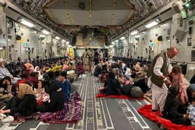 Afghan people sit inside a US military aircraft to leave Afghanistan. Picture by Shakib Rahmani/Getty.