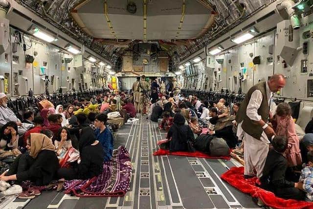 Afghan people sit inside a US military aircraft to leave Afghanistan. Picture by Shakib Rahmani/Getty.