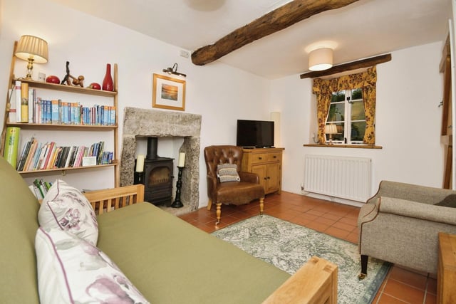 This characterful room contains a stone fireplace with log burner and exposed wooden beams.