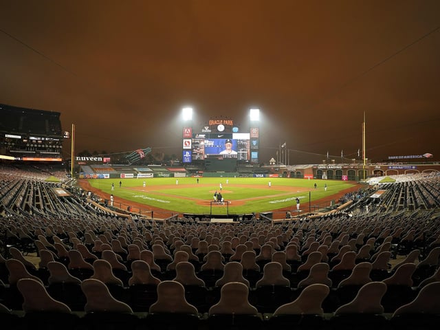 Smoke from California wildfires colors the air above Oracle Park as the San Francisco Giants play the Seattle Mariners.