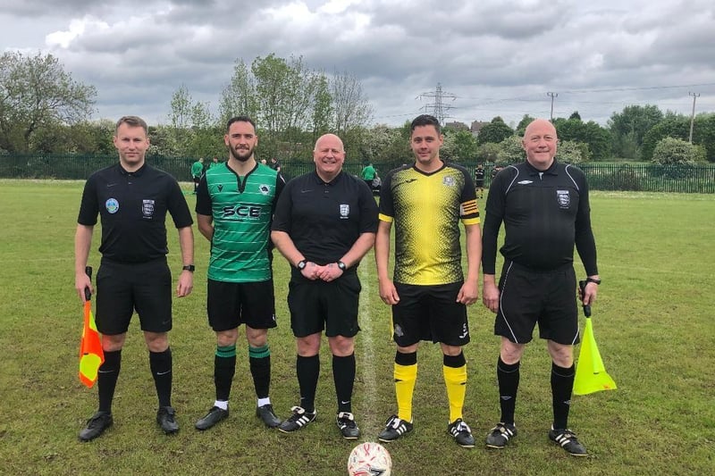 The match officials and captains prepare to get the game underway.