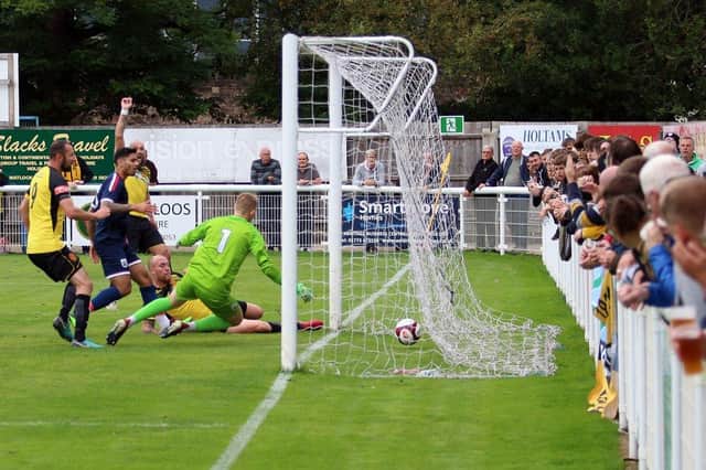 Danny South (on the ground) slides in to score Belper's first goal. Photo: Mike Smith.