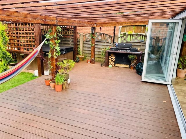 There is a decked area with a hot tub area.