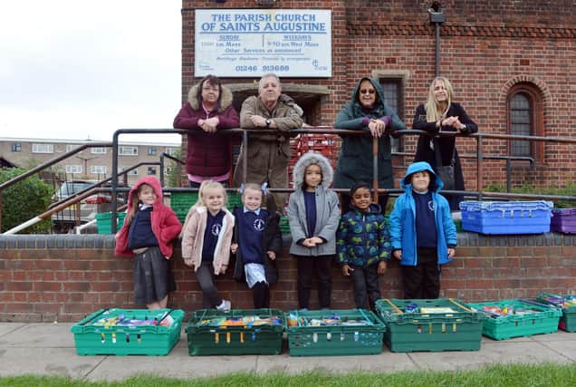 Children from Spire Infant School handing over harvest food donations to Gussie's Kitchen at St Augustine's Church.