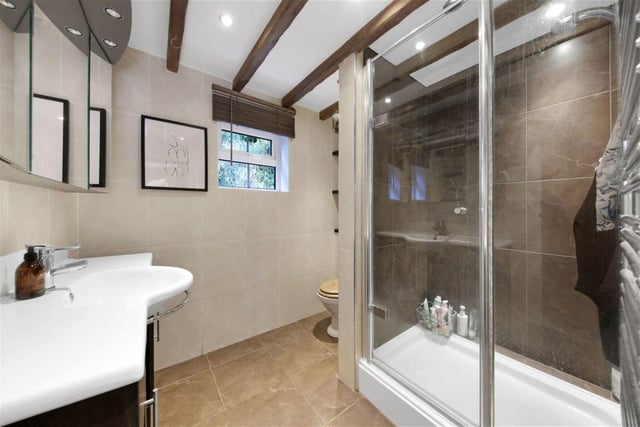 The downstairs bathroom features modern design and a spacious shower.