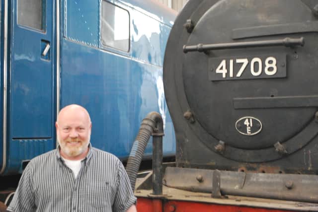 Mervyn Allcock, Barrow Hill general manager, in front of the roundhouse's newest exhibit, former Staveley Iron Works steam locomotive number 41708.