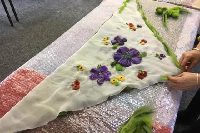 Creating nuno felted silk scarves at the first of the craft workshops.