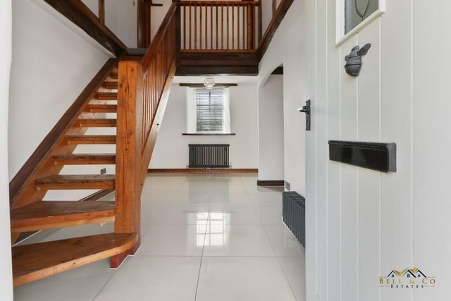The entrance hall, with staircase, sets the tone for the rest of the property, mixing a sparkling renovation with the retention of original features.