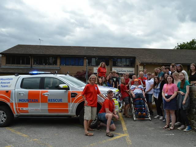 Coun Paul Cruise, on the stretcher, with Highfields students and representatives of his chosen charities.