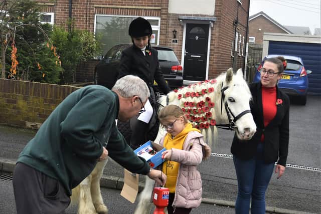 Gary Barber sent us this picture of his grandchildren Isabella and Abigail and their horse Spirit selling poppies.