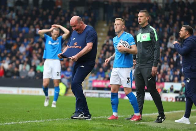 Paul Cook shows his frustration with the referee during the defeat to Stockport.