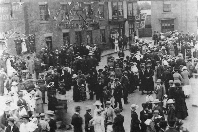 Celebrating the end of World War I, Market Place, Ripley, 1918. Pictured in the background is the Thorn Tree Public House which is still there now. Houses to the right of the photo have been demolished. The Town Hall is off to the right of the photo.  (Photo by NEMPR Picture the Past/Heritage Images/Getty Images)