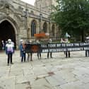 Extinction Rebellion campaigners outside Chesterfield's Crooked Spire church.