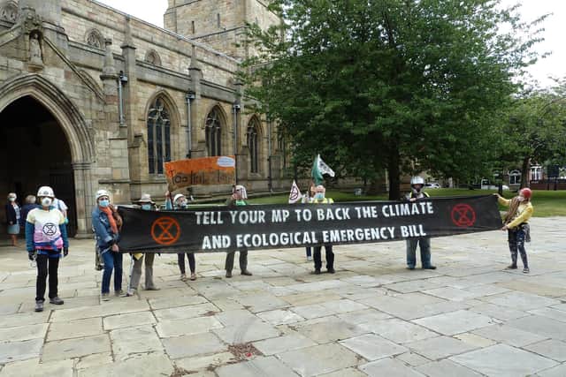 Extinction Rebellion campaigners outside Chesterfield's Crooked Spire church.