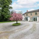 A cherry tree is the focal point of the large driveway with turning circle which leads to the double garage.
