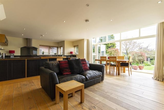 The open-plan layout on the ground floor flows from kitchen to dining area to family  area.
