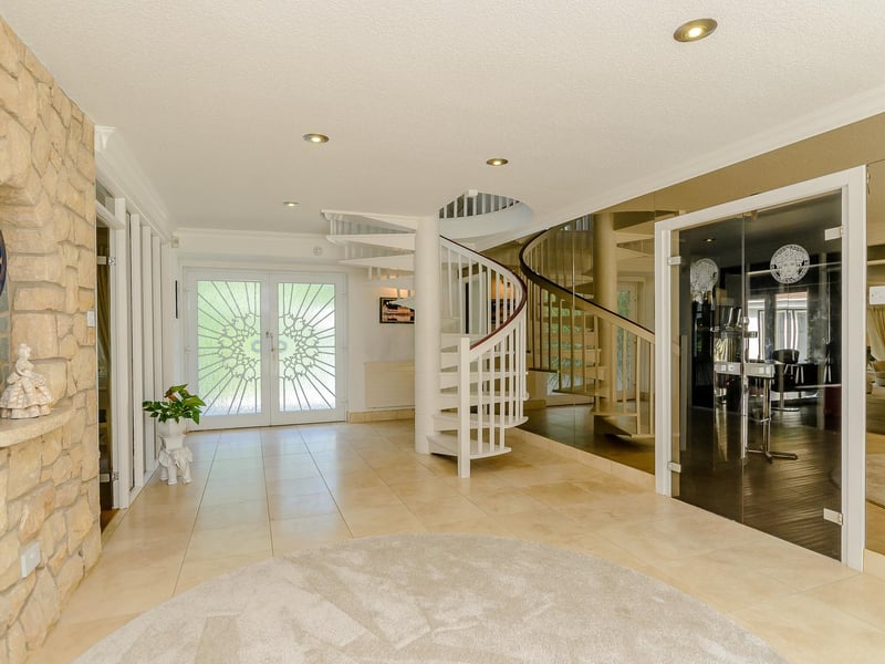 The property opens into this beautiful room with a spiral staircase to the first floor