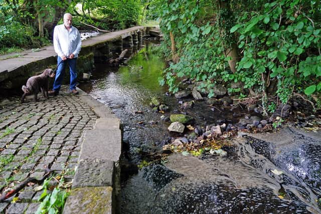 Polluted river Amber at Ashover. Seen local resident Mick Philbin.