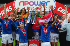 Mark Allott and Dwayne Mattis of Chesterfield celebrate with the trophy after being crowned Champions during the npower League Two match between Chesterfield and Gillingham at the B2Net Stadium on May 7, 2011.