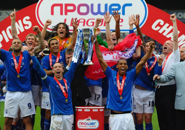 Mark Allott and Dwayne Mattis of Chesterfield celebrate with the trophy after being crowned Champions during the npower League Two match between Chesterfield and Gillingham at the B2Net Stadium on May 7, 2011.