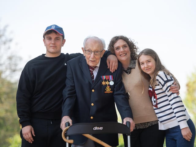 Captain Tom Moore, with (left to right) grandson Benji, daughter Hannah Ingram-Moore and granddaughter Georgia, at his home in Marston Moretaine, Bedfordshire, after he achieved his goal of 100 laps of his garden.