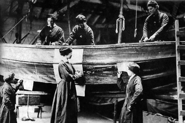 More women at war work. 'Umbrella boats so named as they were made of canvas and collapsible. The women are sowing patches to the hull.  Photograph: George Milliner postcard collection.