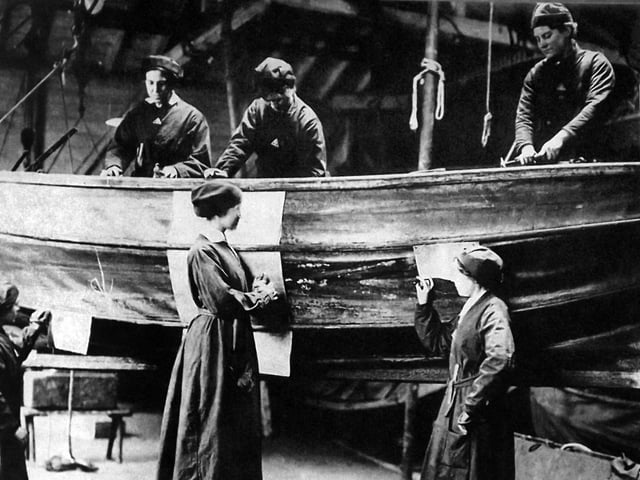 More women at war work. 'Umbrella boats so named as they were made of canvas and collapsible. The women are sowing patches to the hull. Photograph: George Milliner postcard collection.