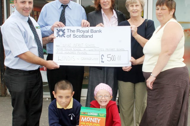 Londis donate money to local schools. Seen here are  Terry Cayton shop owner, Paul Aldred shop manager, Jane Garrett head of Spire infants, Margarie Livesley school governor, Linda Hendersoa school govenor, with John Wright 7yrs. Kelly Booker 7yrs