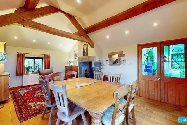 Exposed beams, a multi-fuel stove set on a raised hearth and with a dressed stone surround and an attractive illuminated display niche with a stone surround catch the eye in this lovely room.