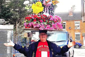 John Evans balances the 7ft 6ins Easter bonnet on his head as he practises for his 105th world record.