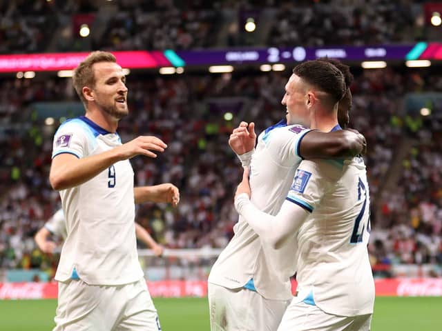 Bukayo Saka celebrates with Harry Kane and Phil Foden after scoring England's third goal against Senegal (Photo by Catherine Ivill/Getty Images)