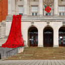 Chesterfield Town Hall has been decorated with a cascade of thousands of woollen poppies knitted and crocheted by local residents.