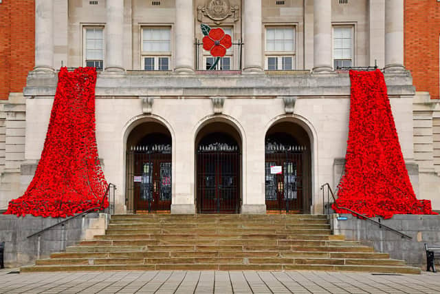 Chesterfield Town Hall has been decorated with a cascade of thousands of woollen poppies knitted and crocheted by local residents.