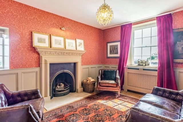 A cast brass and iron horseshoe fireplace with minstrel stone surround is showcased in this versatile reception room which offers an additional lounge or dining area. There is open shelving for books, solid oak boarded flooring and Georgian style windows.