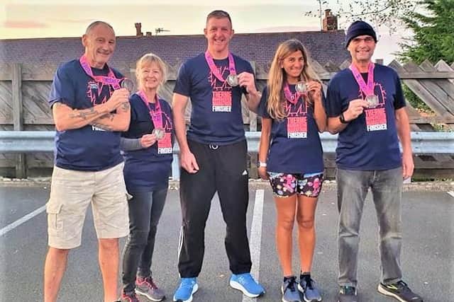 Baz Gillett, Susan Coleman, Antony Goulding, Anita Hicks and Daniel Coleman proudly display their medals from the Manchester Marathon.