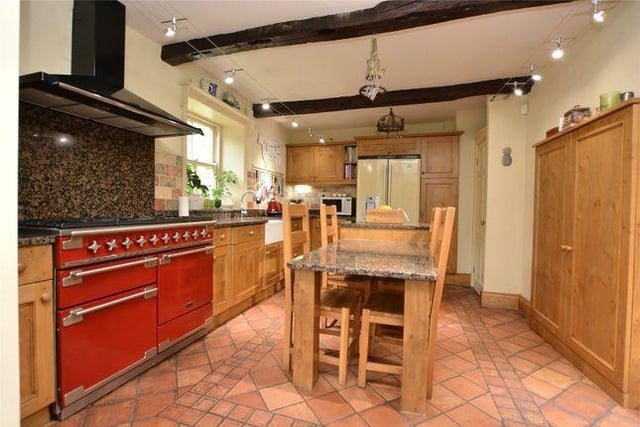 The beautiful kitchen boasts bespoke fitted wall and base units