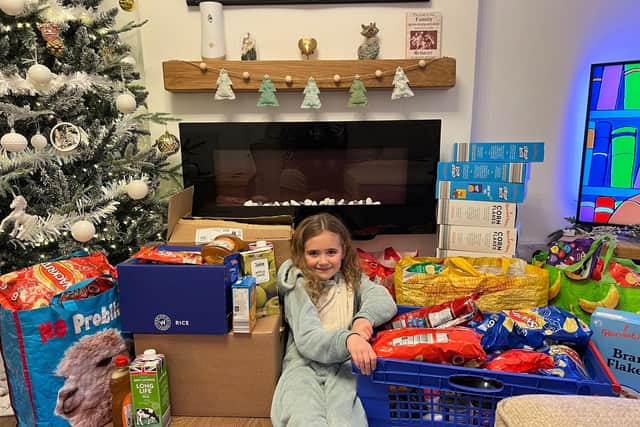 Kennedy Brentnall with some of the donations that she collected for Chesterfield Foodbank.