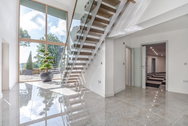 A contemporary staircase takes you to the lower ground floor which is flooded with natural light through the full height picture window.