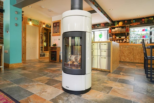 A focal point of the kitchen/diner is an Italian double-sided wood burning stove which is also visible from the open-plan lounge area.