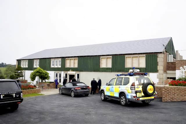 Police raid the shed come mansion that was owned by Alan Yeomans.