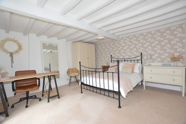 All five bedrooms are an excellent size, including this one, which even has room for a desk. Again, the beamed ceiling is an attractive feature.