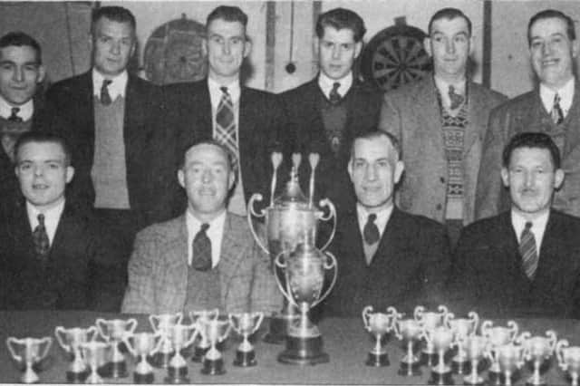 Crich Comrades Club darts team with a haul of trophies in 1948. Pictured standing, left to right, are: George Bratley, Herbert Turner, Bill Martin, Henry Heappy, Bill Critchlow, Clarence Hartshorne; seated, Joe Redfern, Jim Tomlinson, Wilf Wragg, Jack Holtham.