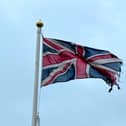 Tatterd flag around a lamp posts.