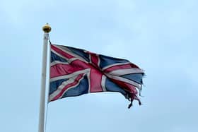 Tatterd flag around a lamp posts.