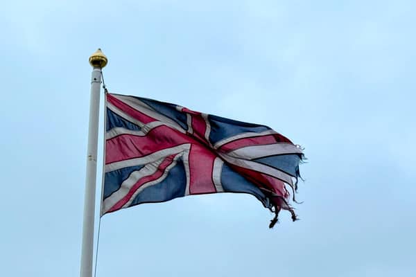 Tatterd flag around a lamp posts.