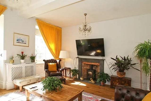 The sitting room has sash windows looking onto the garden and a fireplace with slate surround and hearth that houses a living flame gas stove.
