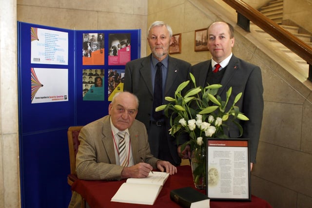 Cllrs. signing Holocaust book l to r Cllr.John Burrows,Cllr. Ray Russel,Borough council C E Huw Bowen